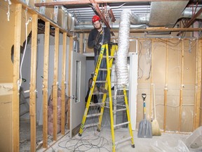 Electrician Brandon Henson works at the Glen Cairn Community Resource Centre where  the city's first low-income dental clinic is being constructed. (Derek Ruttan/The London Free Press)