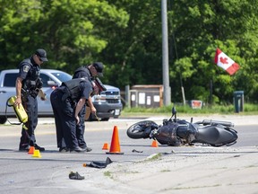 Police investigate a collision between a motorcycle and man walking his dog across Highbury Avenue at Kilally Road  in London, Ont. on Wednesday June 17, 2020. Both men were taken to hospital. The pedestrian is in serious condition. The motorcyclist is stable condition. The dog did not survive. Derek Ruttan/The London Free Press/Postmedia Network