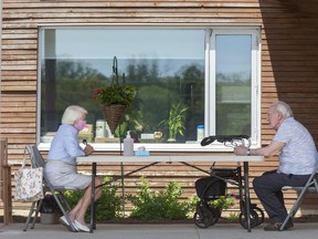 Betty Morris visits with her husband Victor outside of the McCormick Home where Victor resides in London, Ont. on Thursday June 18, 2020. (Derek Ruttan/The London Free Press)
