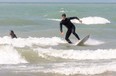 Curtis Parker of Etobicoke gets a short ride on the waves at Port Stanley's main beach south of London, Ont. on Wednesday June 10, 2020.  The beach remains closed, so the surfers had to walk out from the base of the pier, to avoid using the beach. All though the beach closed signs are gone, walkers and parents sitting with their children, were told to leave the beach by an active beach patrol, who said they didn't know when the beach would reopen, but it wouldn't be this weekend. (Mike Hensen/The London Free Press)