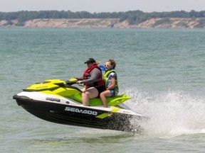 A personal watercraft (jet ski) leaps out of the water over a swell in front of the main beach in Port Stanley. Mike Hensen/The London Free Press)