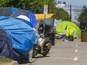 Between the Salvation Army's Centre of Hope and the CN rail lines is a small tent city in London, Ont.  (Mike Hensen/The London Free Press)