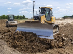Heavy machinery from L82 construction is filling in the route for the extension of Veterans Memorial Parkway, expected to help the industrial areas of the city. (Mike Hensen/The London Free Press)