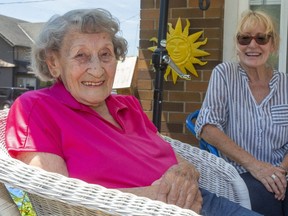 Barb McLoughlin, 99, seen here with  daughter Kathy Stirrat at their Port Stanley  home, turns 100 on Canada Day Wednesday. COVID-19 put paid to plans for a big bash at the Legion, so Stirrat has organized a smaller family party and a July 1 drive-by celebration instead. (Mike Hensen/The London Free Press)