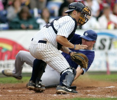 CANADA DAY 2009: Mason Reilly of the London Majors waits for the ball while Kyle Morton of the Toronto Maple Leafs slides into home, scoring the tying fourth run in the top of the fourth inning after a bases-loaded sacrifice fly during the first game of their Canada Day doubleheader in Labatt Park. (Mike Hensen/The London Free Press)