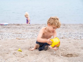 Siblings Brooklyn, and Mason Dean, ages six and five, were among the first wave of kids to arrive at Grand Bend's beach as it reopened Monday. Said their mom, Caroline: “The kids were very excited, they couldn’t wait to get to the beach.” Photo taken Monday June 22, 2020. (Max Martin/The London Free Press)