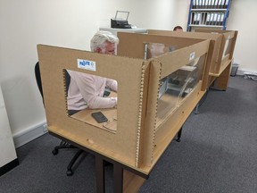 Staff at Pallite work at their desks while protected from colleagues by the company’s cardboard social distancing screens, following the outbreak of the coronavirus disease (COVID-19), at their HQ in Wellingborough, Britain on May 27, 2020. (REUTERS/Stuart McDill)