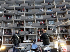 Musical group The Lost Boys perform during a so-called balcony concert in downtown Calgary on Canada Day. (Darren Makowichuk/Calgary Herald)
