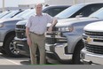 Mickey Pierre, a salesman at Gus Revenberg Chevrolet Buick GMC in Windsor, is shown on Friday, June 19, 2020, with new Chevrolet pickups which he says have been a hot seller recently. (DAN JANISSE/The Windsor Star)