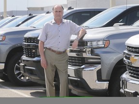 Mickey Pierre, a salesman at Gus Revenberg Chevrolet Buick GMC in Windsor, is shown on Friday, June 19, 2020, with new Chevrolet pickups which he says have been a hot seller recently. (DAN JANISSE/The Windsor Star)