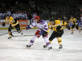 Kingston's Jakob Brahaney reaches for Kitchener's Eric Guest during the Frontenacs OHL game against the Rangers  in 2018. Guest has posted a video alleging hazing rituals, bullying and humiliation he endured on the team. (Meghan Balogh/Postmedia Network)