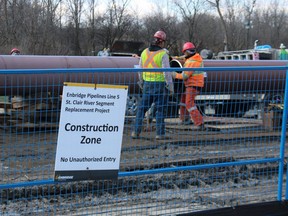 Crews are shown in this file photo connecting sections of pipe for an Enbridge pipeline replacement crossing beneath the St. Clair River.