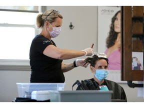 Tangles Hair Spa owner Jodie Scherer, left, works with customer Andrea Rutgers on Pearl Street Tuesday, the first day of Stage 2 for Kingsville and Leamington.
