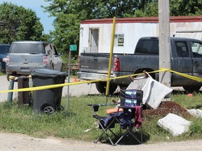 OPP officers guarded the scene Tuesday, July 14, 2020, at a Clara Road property at the centre of a death investigation on Oneida Nation of the Thames. (Dale Carruthers, The London Free Press)