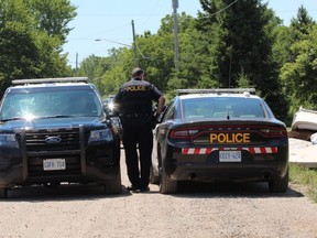 OPP officers guarded the scene Tuesday, July 14, 2020, at a Clara Road property at the centre of a death investigation on Oneida Nation of the Thames. (Dale Carruthers, The London Free Press)