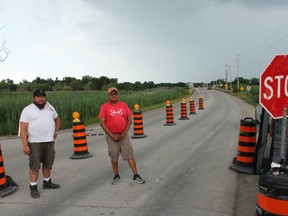Walpole Island security guards Cody Miskokomon, left, and Brad Lallean enforce the bridge checkpoint leading into the First Nation on July 29. Walpole Island First Nation council voted to extend the checkpoint until the end of August on July 28. Jake Romphf