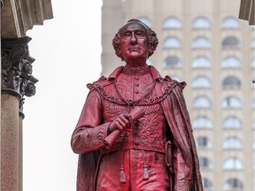 The statue of Sir John A. Macdonald in Montreal's Place du Canada is seen vandalized in 2018. The country's first prime minister launched the Indian Residential Schools system, Tomas Jirousek notes.
