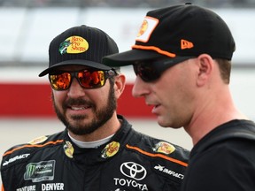 Martin Truex Jr., driver of the #78 Bass Pro Shops/5-hour ENERGY Toyota, and crew chief Cole Pearn talk on the grid prior to the Monster Energy NASCAR Cup Series Bojangles' Southern 500 at Darlington Raceway on September 2, 2018 in Darlington, South Carolina.  (Photo by Josh Hedges/Getty Images)