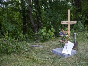 A memorial has been placed at the location where police removed suspected human remains in a wooded area off Jaqueline Street near Ada Street in London, Ont. (Derek Ruttan/The London Free Press)