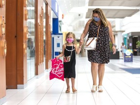 Helen Pegg and her six-year-old granddaughter Danica Jukema wear masks while shopping at White Oaks Mall. They were searching for a birthday gift for Danica, who turned six in March. (Derek Ruttan/The London Free Press)