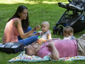 Maria and Caesar Yanez relax at the Civic Garden Complex with their 16 month old twins Ethan (left) and Ella. Photo shot in London. (Derek Ruttan/The London Free Press)
