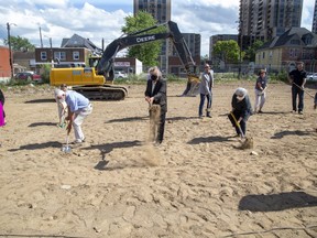 Mayor Ed Holder, centre, was joined by others in a groundbreaking ceremony at the former site of the Embassy Hotel on Dundas Street in London on Wednesday. It will be the site of the Embassy Commons, a 72-unit apartment building that will offer supportive housing. (Derek Ruttan/The London Free Press)