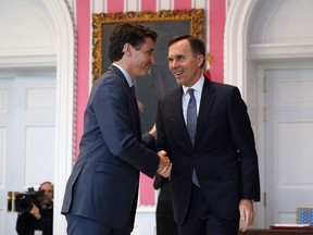 Prime Minister Justin Trudeau shakes hands with Minister of Finance Bill Morneau at Rideau Hall as he swears in his latest cabinet in November, 2019.