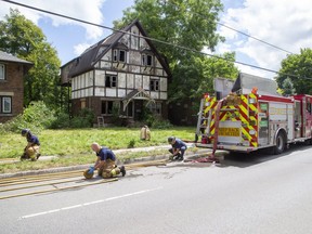 London firefighters pack up their gear after dousing a blaze that severely damaged a vacant house at 1240 Richmond St. on Monday July 13. (Derek Ruttan)