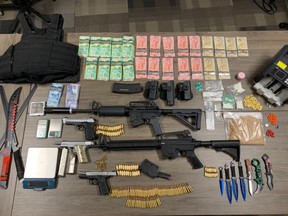 Two people are charged after St. Thomas police seized $35,000 in drugs, $24,000 cash, four guns and other items from a Talbot Street apartment on Thursday, police said. (St. Thomas police photo)
