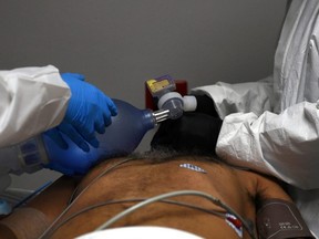 Medical workers treat a coronavirus disease patient at the United Memorial Medical Center's COVID-19 intensive care unit in Houston, June 29, 2020.