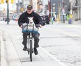 Mike Wakulicz and his best friend "George" enjoy bike ride along Dundas Street in London, Ont. on Friday May 1, 2020. "She loves it," said Wakulicz. "As soon as she sees the bike she knows she's going on an excursion." (Derek Ruttan/The London Free Press)