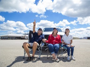 Airshow London chair Jim Graham, wife Charmaine and daughter Madeline show off Airshow London's new Skydrive model at London International Airport Monday, July 13. The two-day September show will see visitors drive onto airport grounds to watch flying displays in socially distanced safety and follow the action on their car radios. (Derek Ruttan/The London Free Press)