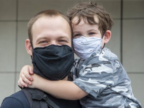 Four-year-old Nigel Drury and dad Tyler Drury were masked up in London Thursday, July 16, as debate rages in the city over whether to make masks mandatory indoors to fight COVID-19. (Derek Ruttan/The London Free Press)