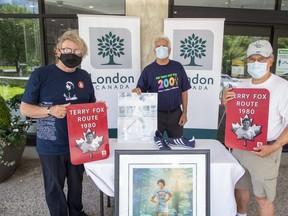 London Mayor Ed Holder, left, Terry Fox Run organizer Paul Cox and Keith Tapp, who has participated in every Terry Fox Run, were at city hall Friday, July 17, 2020,  to show off 38 commemorative signs to be hung along the route Terry Fox took through London during his Marathon of Hope  40 years ago. (Derek Ruttan/The London Free Press)