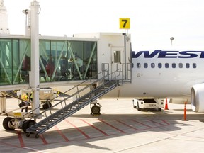 Passengers use a jetway to disembark from a WestJet 737 at London International Airport on Friday May 17, 2019. (Free Press file photo)