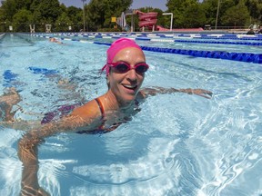 Becky Jennison, a triathlete smiles as she glides into the wall during lap swimming in the newly opened Thames Park pool after it opened Saturday. Lap swimming will be limited to two swimmers a lane making registering important to get a space. Jennison, was asked how important was it to get the pool opened, "Oh my god, it's super important, just the social aspects, enjoying the outdoors with other humans," said Jennison. Photograph taken on Monday July 6, 2020.  (Mike Hensen/The London Free Press)