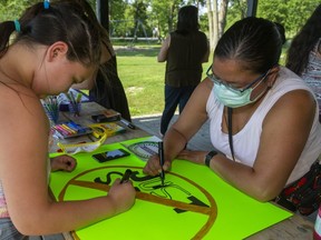 Lakoterashwi;io Herne and her grandmother Melissa Doxtator work on a sign saying Just Say No for a walk against drugs in Oneida planned for Friday. The walk is being organized by the women in the community west of London. (Mike Hensen/The London Free Press)