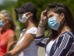 Liz Snelgrove, left, Kirsten Krose and Sarah Browning wait in the sun with masks on at Highland Country Club in London Friday, July 17. Masks will be mandatory in all indoor public spaces in London and Middlesex County starting Saturday, July 18. (Mike Hensen/The London Free Press)