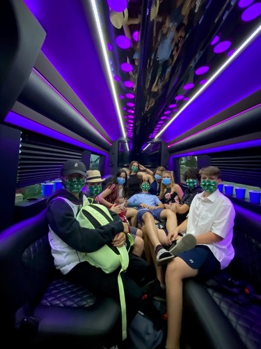 Youngsters in masks go on a trip inside a Wave Limousine.
