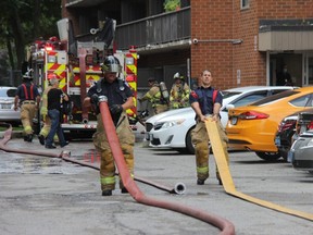 London firefighters work at the scene of a fire at a public housing highrise on Simcoe Street Tuesday, which caused $50,000 damage to an eighth-floor unit. (Jonathan Juha/The London Free Press)