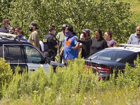 Rocks could be heard hitting police vehicles as Ontario Provincial Police officers are slowly pushed back by a large group of indigenous protesters gather in Caledonia over the noon hour on Wednesday August 5, 2020. Earlier in the morning, a large contingent of police removed protesters occupying a nearby residential construction site, prompting supporters from the nearby Six Nations of the Grand River Territory to arrive.  (Brian Thompson/Postmedia Network)