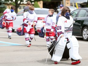 Riverside Rangers players walk through the parking lot at the Tilbury and District Memorial Community Centre in Tilbury before a game on Sunday. Mark Malone/Postmedia Network