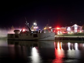 Central Elgin firefighters are seen on a boat that caught fire Saturday night in Port Stanley. Photo courtesy of Luke Durda.