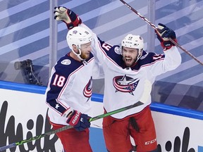 Liam Foudy, right, of the Columbus Blue Jackets celebrates his third-period goal with Pierre-Luc Dubois in Game 5 of the Eastern Conference Qualification Round against the Toronto Maple Leafs on Aug. 9 at Scotiabank Arena in Toronto. (Andre Ringuette/Freestyle Photo/Getty Images)