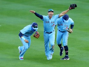 Toronto Blue Jays centre-fielder Randal Grichuk, centre, celebrates a win over Philadelphia Phillies with teammates at Sahlen Field in Buffalo, Aug. 20, 2020.