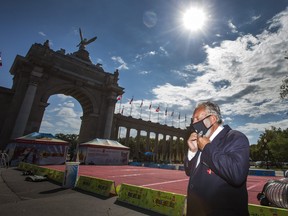Canadian National Exhibition president John Kiru puts on a mask at the opening of the virtual CNE. on Friday August 21, 2020.  Ernest Doroszuk/Toronto Sun/Postmedia