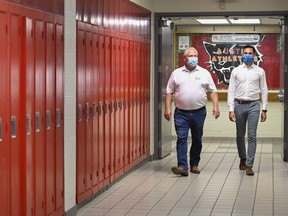 Ontario Premier Doug Ford, left, and Education Minister Stephen Lecce walk the hallway before making an announcement regarding the governments plan for a safe reopening of schools in the fall due to the COVID-19 pandemic at Father Leo J Austin Catholic Secondary School in Whitby, Ont., on Thursday, July 30, 2020.