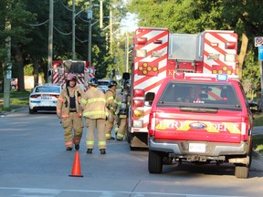 Firefighters and police were on the scene Friday morning on Grey Street, where a vehicle struck a home and severed a gas line, prompting evacuation of nearby homes. {Dale Carruthers/The London Free Press}