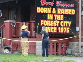 Police and fire investigators are on the scene Monday after a suspicious weekend fire damaged a King Street duplex linked to the nearby Beef Baron strip club. No one was hurt in the early morning Sunday blaze. (Dale Carruthers/The London Free Press}