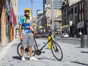 Arkadiusz Broniarz is participating in the Great Cycle Challenge, a fund raiser for SickKids Foundation. He had to replace his bicycle that was stolen from this spot on Dundas Street in downtown London. (Derek Ruttan/The London Free Press)
